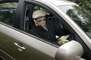 A very old man with a valid driving license drives his car.
