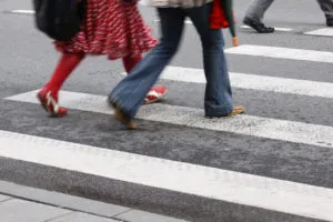 People walking across pedestrian lane.