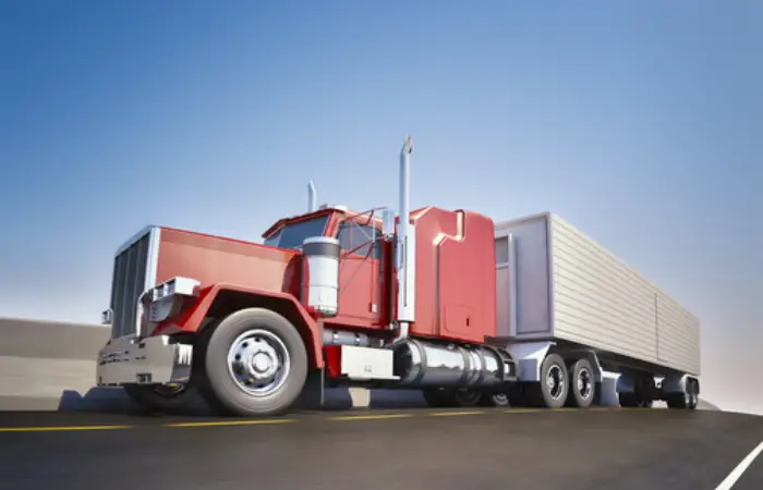 A red semi truck on a busy road
