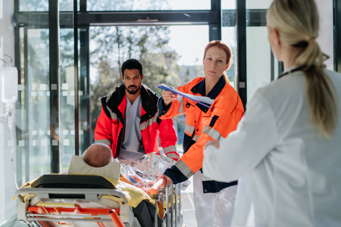 Rescuers bringing patient with serious injury to hospital